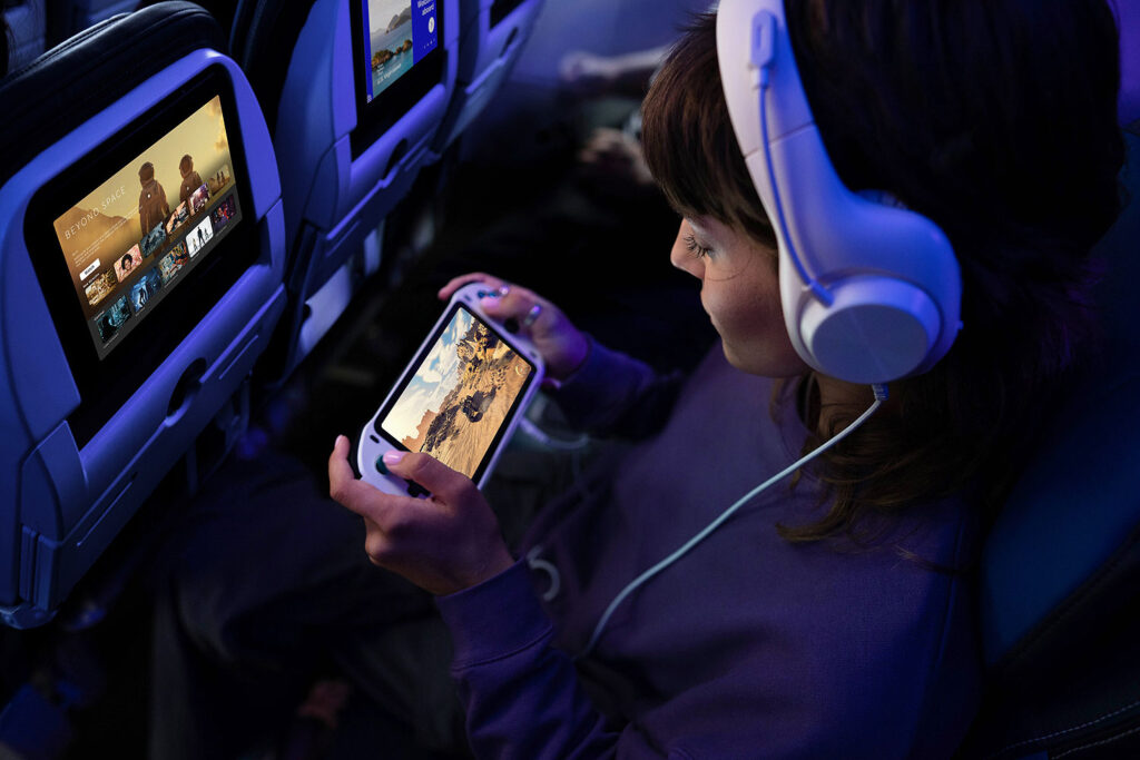 United Airline passenger using device.